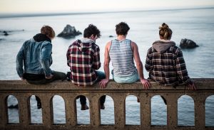An INFJ personality sits with a group of friends, reflecting on his strengths.