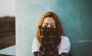 an introvert with social anxiety hides her face