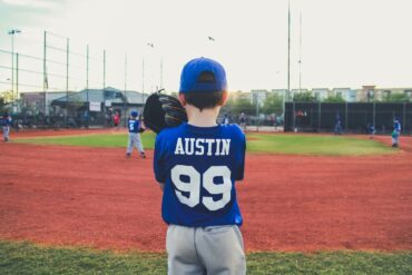 a boy plays baseball