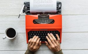 An introvert writes on a typewriter.