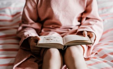 an introverted girl reads a fiction book