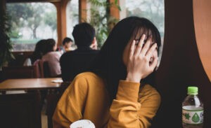 A shy introvert hides her face
