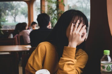 A shy introvert hides her face