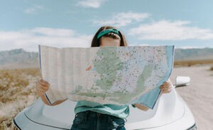 An introvert on a road trip, looking at a map
