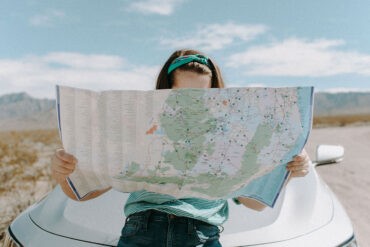 An introvert on a road trip, looking at a map