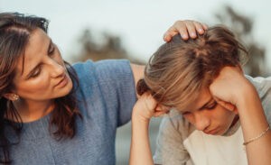 A mother comforts her highly sensitive introvert teenager