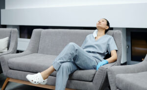 An introverted nurse rests on a couch