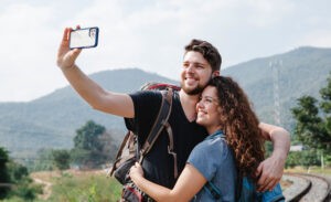 A happy introvert-extrovert couple pose for a selfie