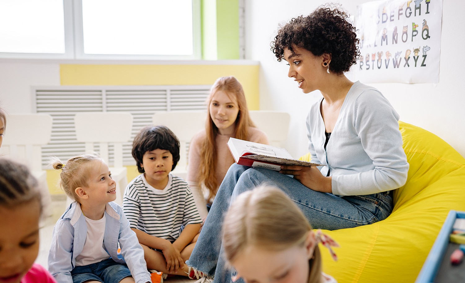 A teacher reads to her introverted students.