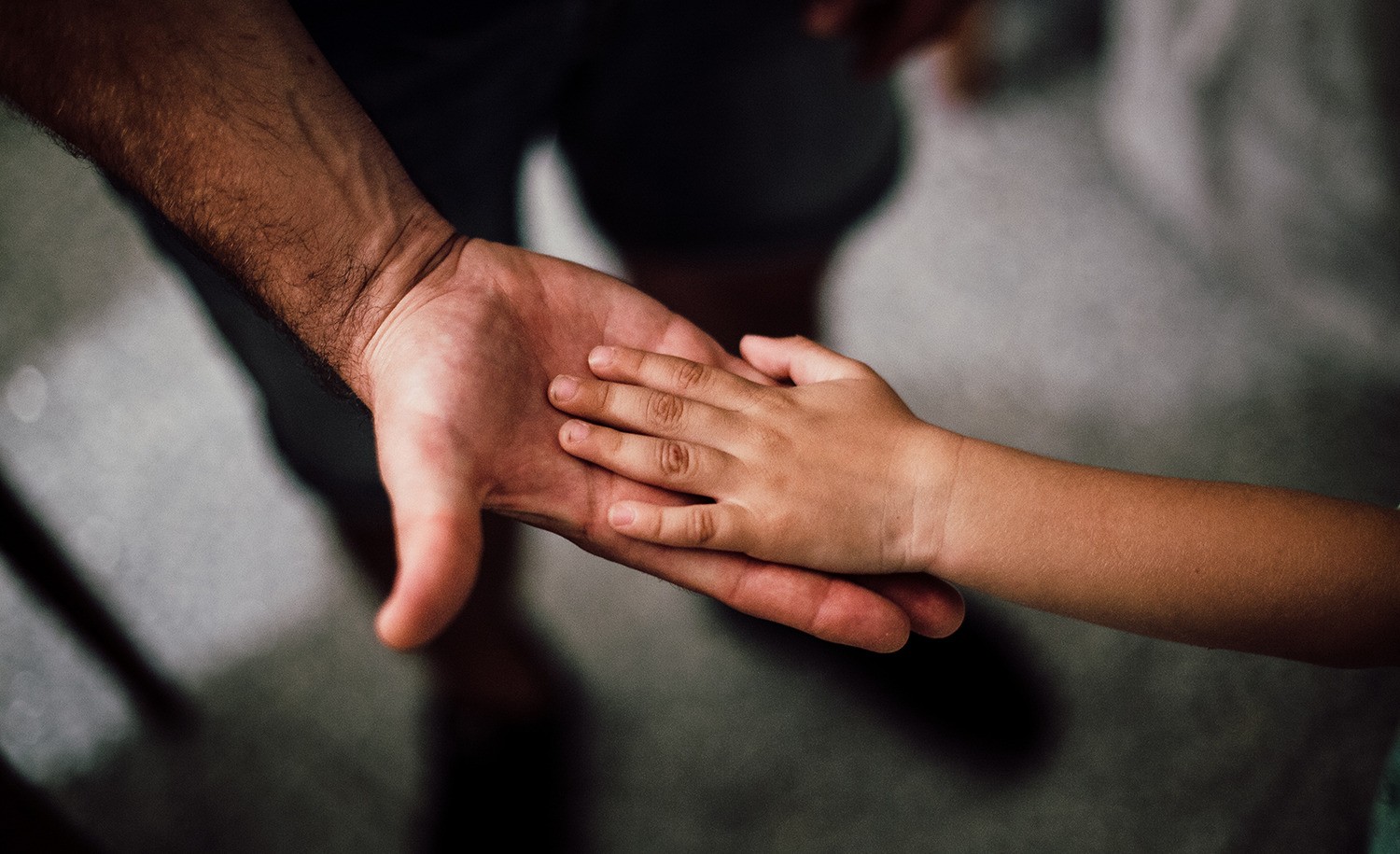 A father holds his son’s hand