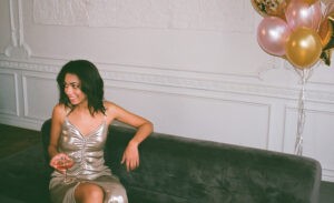 An introvert sitting on a couch alone at a party