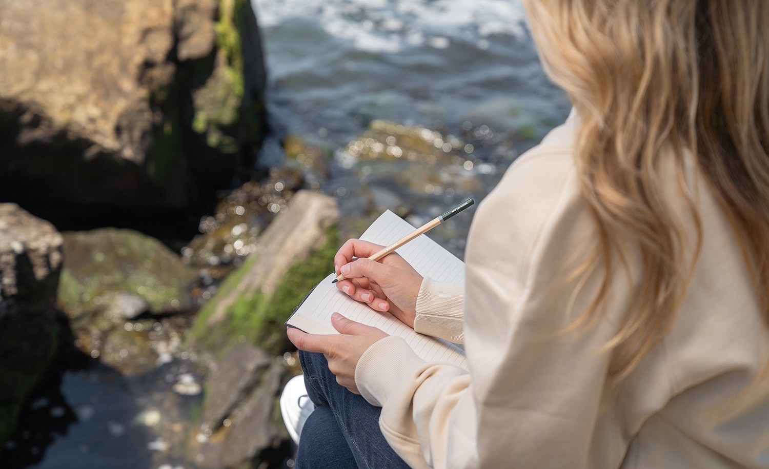 An introvert journals by the water